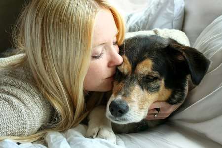 woman kissing sick dog